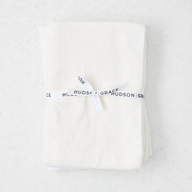 Stack of 6 white cotton flour sack towels, tied with a white "Hudson Grace" ribbon.
