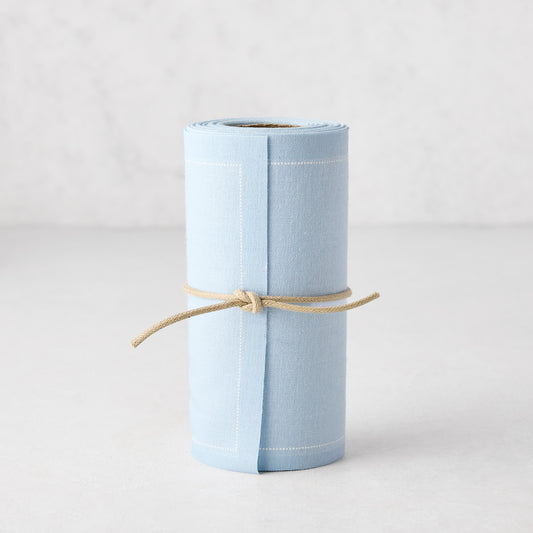 Roll of 50 Foggy Blue tear-off cotton cocktail napkins, tied with natural twine.