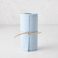 Roll of 50 Foggy Blue tear-off cotton cocktail napkins, tied with natural twine.