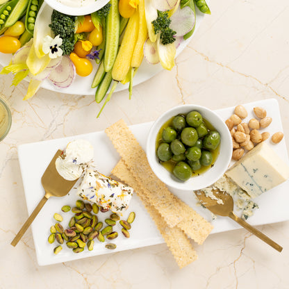 Forged gold 3-piece cheese knife set with hammered texture, shown with cheese, olives, and crackers.