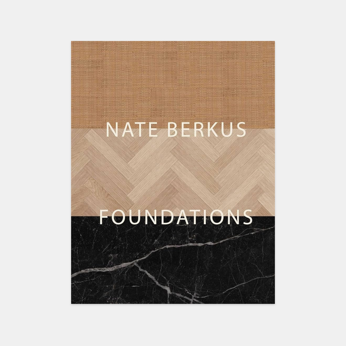 Hardcover "Foundations" book by Nate Berkus, featuring a top burlap, middle herringbone wood, and bottom black marble design.