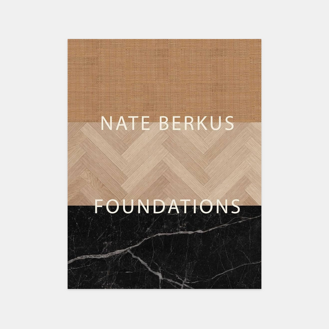 Hardcover "Foundations" book by Nate Berkus, featuring a top burlap, middle herringbone wood, and bottom black marble design.