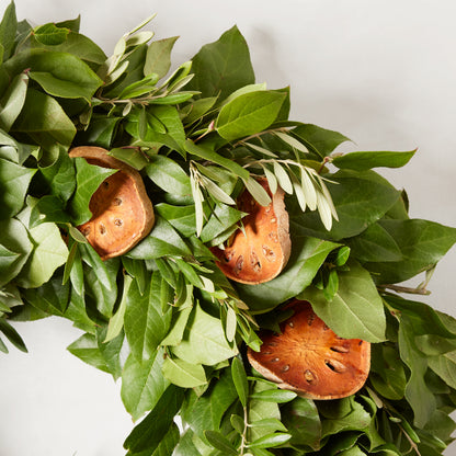 Fresh Citrus Sunrise Wreath with green olive and salal leaves, adorned with dried citrus slices.