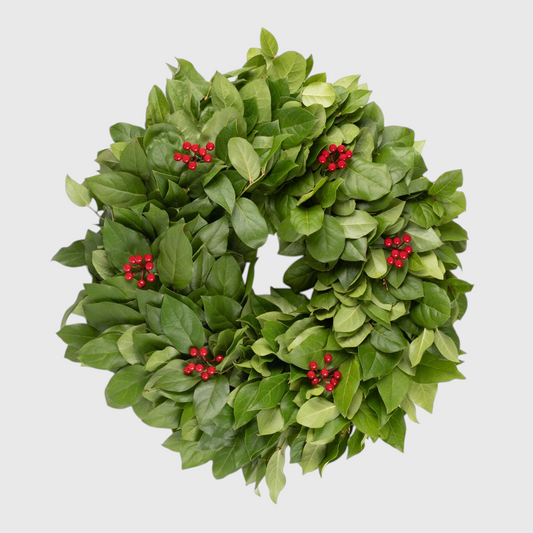 18-inch round wreath featuring lush green salal leaves accented with clusters of vibrant red berries.