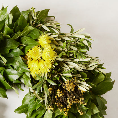 Fresh Spring Meadow Wreath with green olive and salal leaves, bright yellow everlasting flowers, and gold phylica.