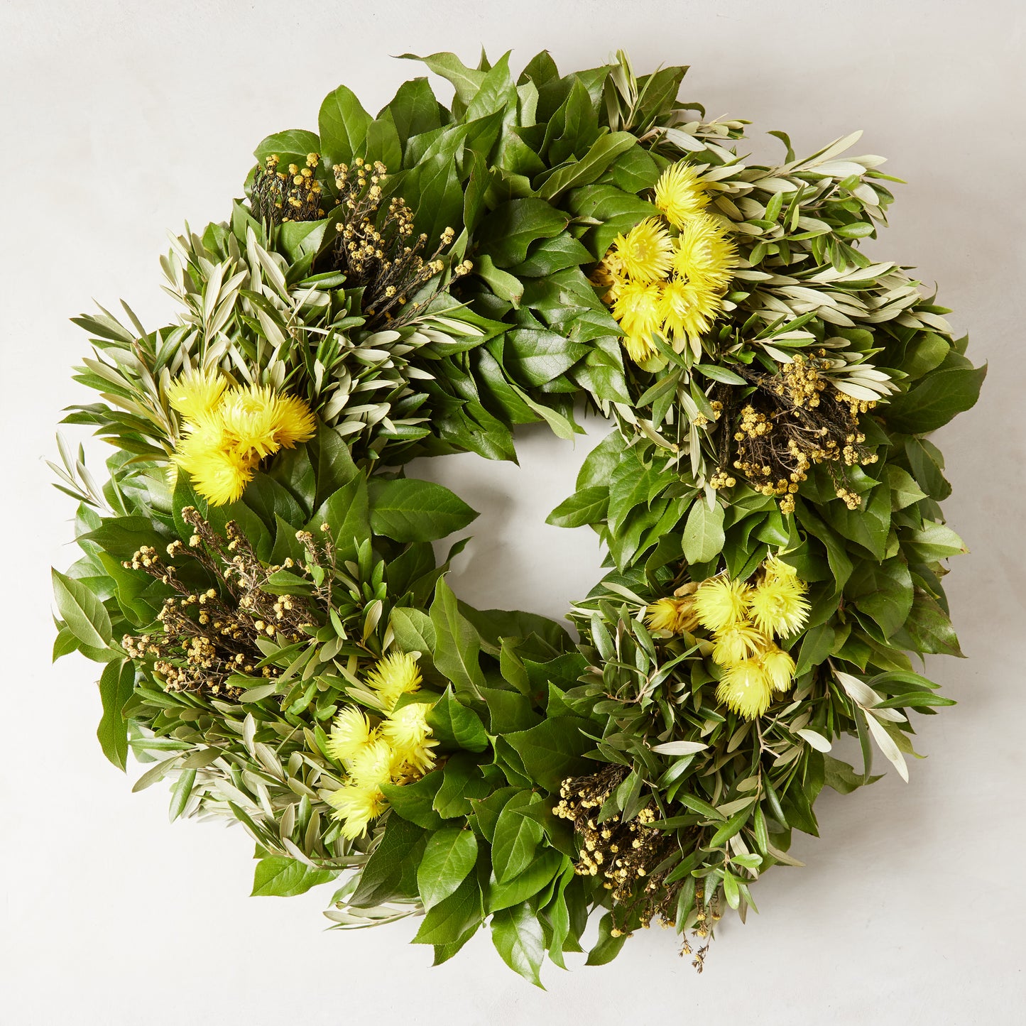 Fresh Spring Meadow Wreath with green olive, salal, yellow everlasting flowers, and gold phylica.