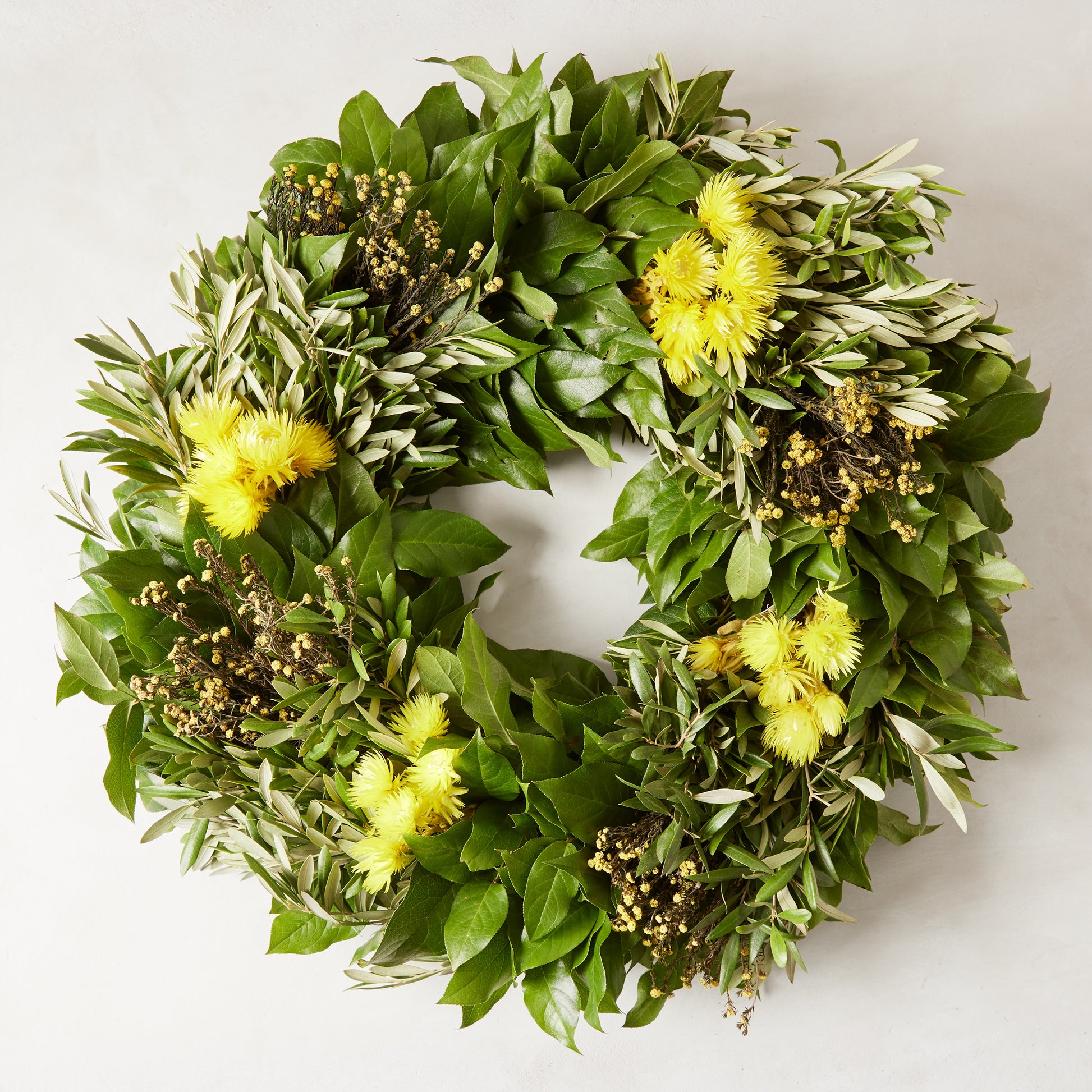 Fresh Spring Meadow Wreath with green olive, salal, yellow everlasting flowers, and gold phylica.