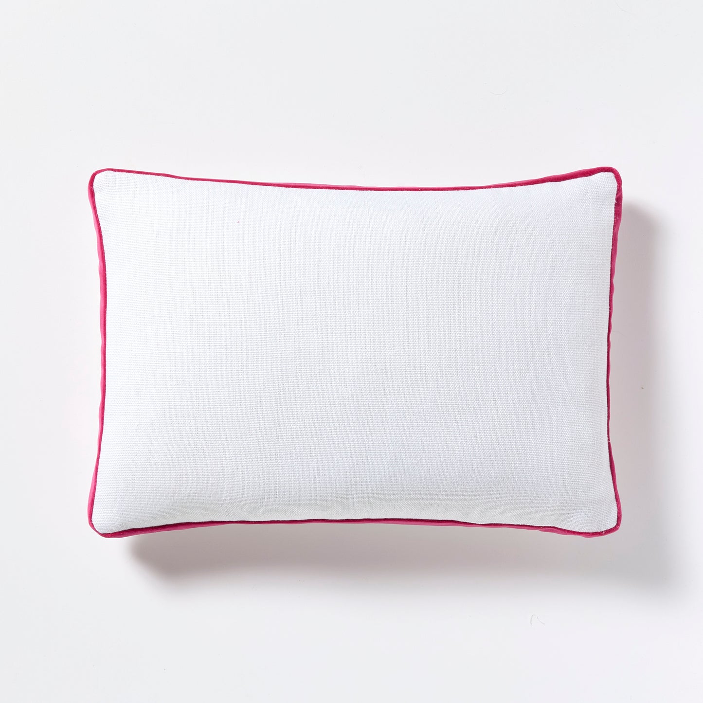 White linen lumbar pillow with fuchsia pink velvet gusset, 20"L x 14"H.