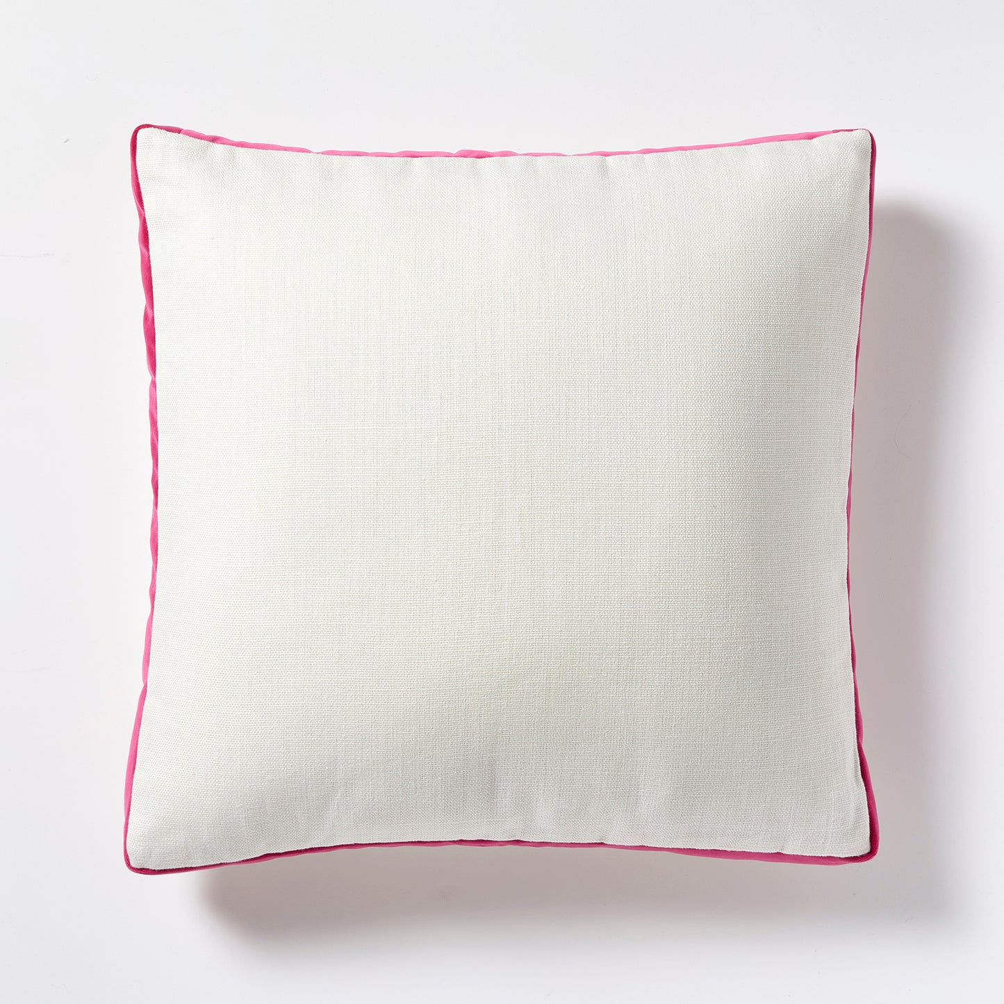 Square white linen pillow with fuchsia pink velvet gusset and piping.