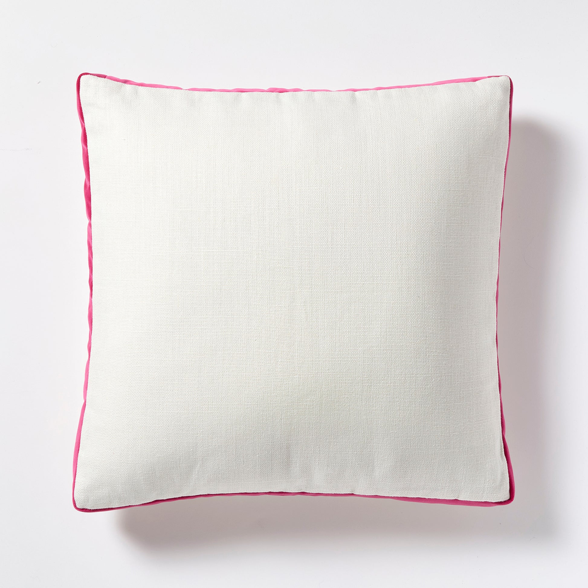 Square white linen pillow with fuchsia pink velvet gusset and piping.