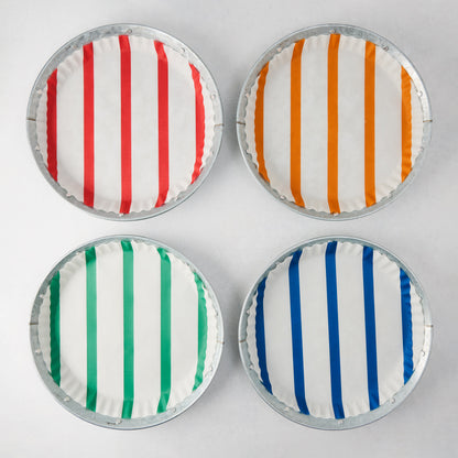 Set of 4 galvanized metal plates with colorful striped parchment liners: red, orange, green, and blue.