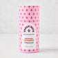 Geaux Nuts Original Cinnamon Pecans in a pink cylindrical container with red fleur-de-lis pattern.