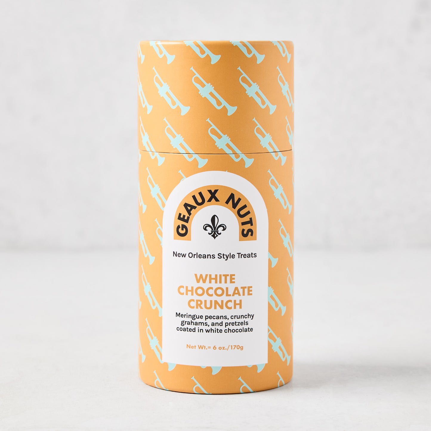 Geaux Nuts White Chocolate Crunch in an orange tube with light blue trumpet pattern and white label.