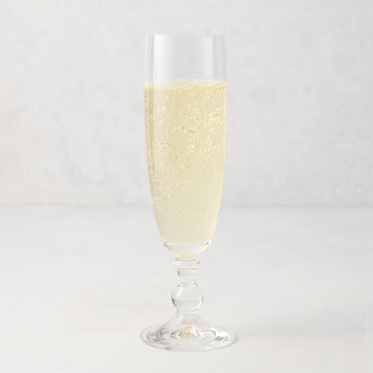 Georgia Eco-Crystal Champagne Glass, 8oz, filled with sparkling champagne, ribbed glass design.