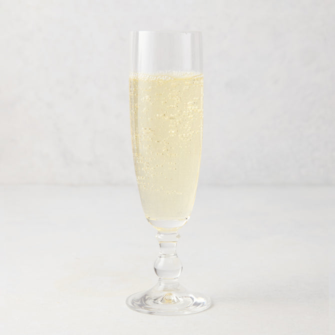 Georgia Eco-Crystal Champagne Glass, 8oz, filled with sparkling champagne, ribbed glass design.