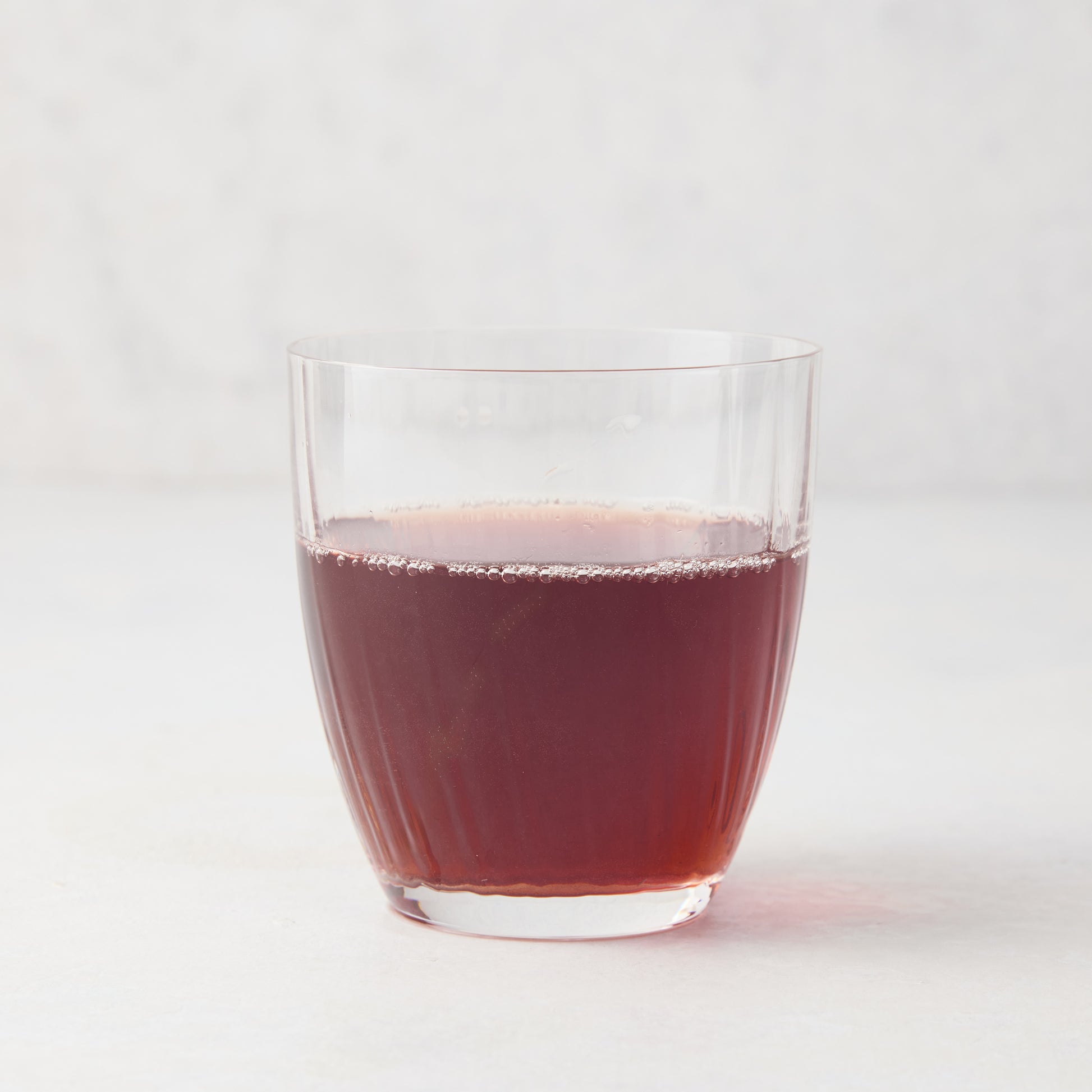 Georgia Eco-Crystal Double Old-Fashioned Glass, 9oz, with ribbed design, filled with red liquid.