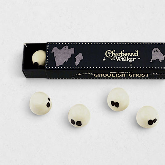 Charbonnel et Walker white chocolate ghost truffles with black eyes, presented in a black Halloween-themed gift box.
