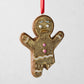 4.5-inch gingerbread man Christmas ornament made of hand-painted glass and resin with glitter and icing details.