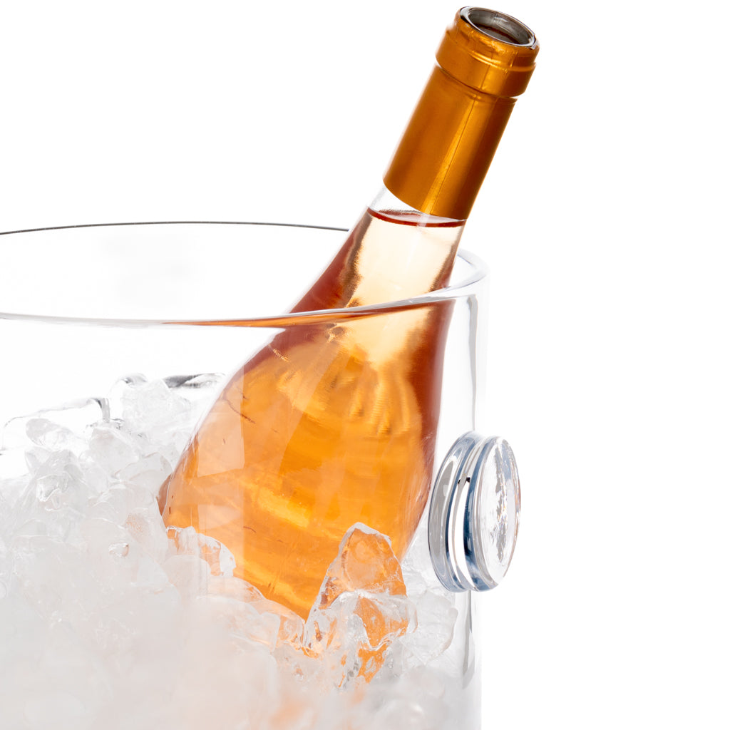 Clear handblown glass ice bucket with knob handles, holding a rose wine bottle in ice.