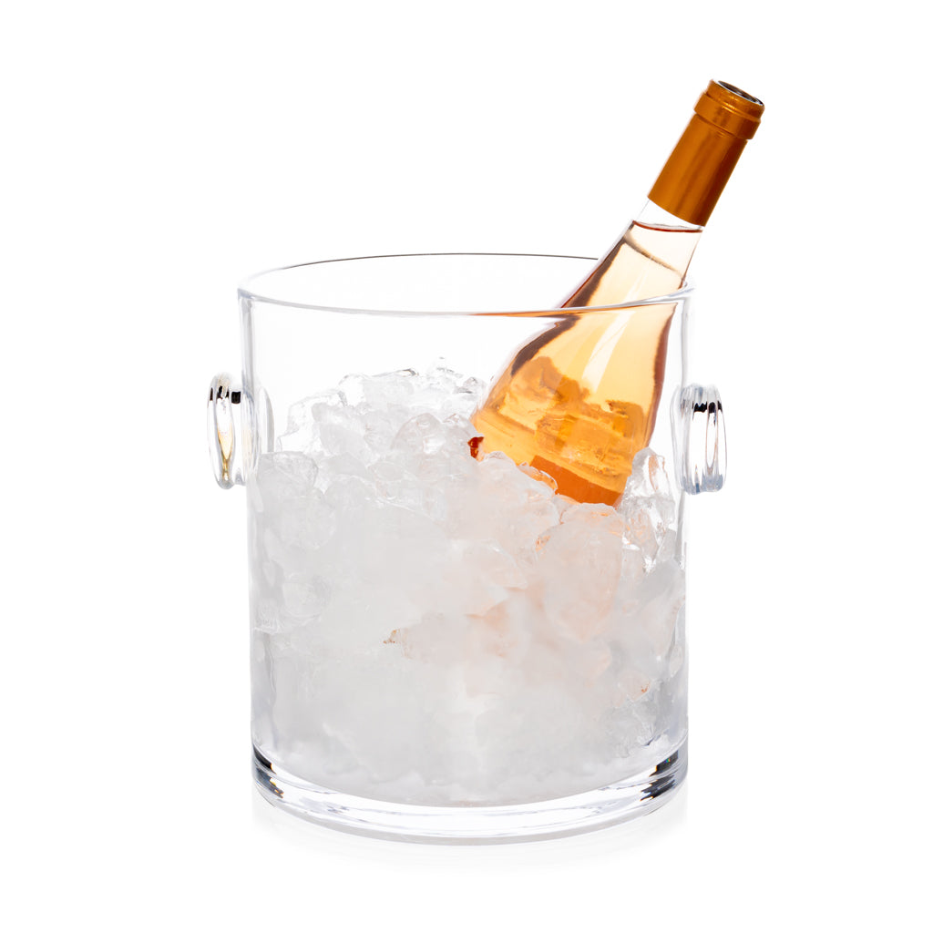 Clear handblown glass ice bucket with knob handles, holding ice and a bottle of rosé wine.