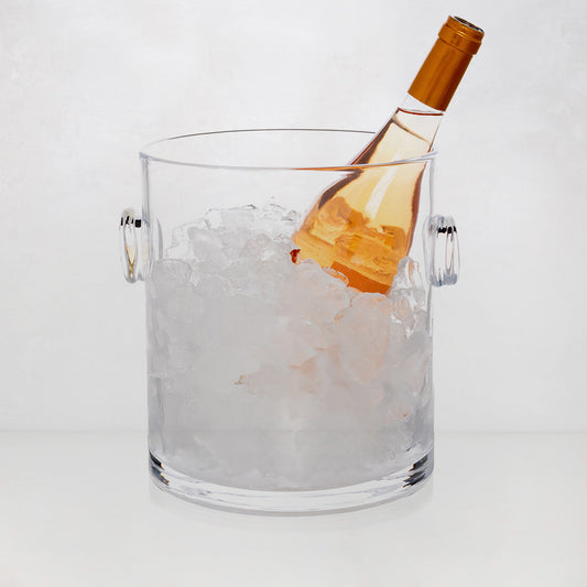 Handblown clear glass ice bucket with knob handles, filled with ice and a rose wine bottle.