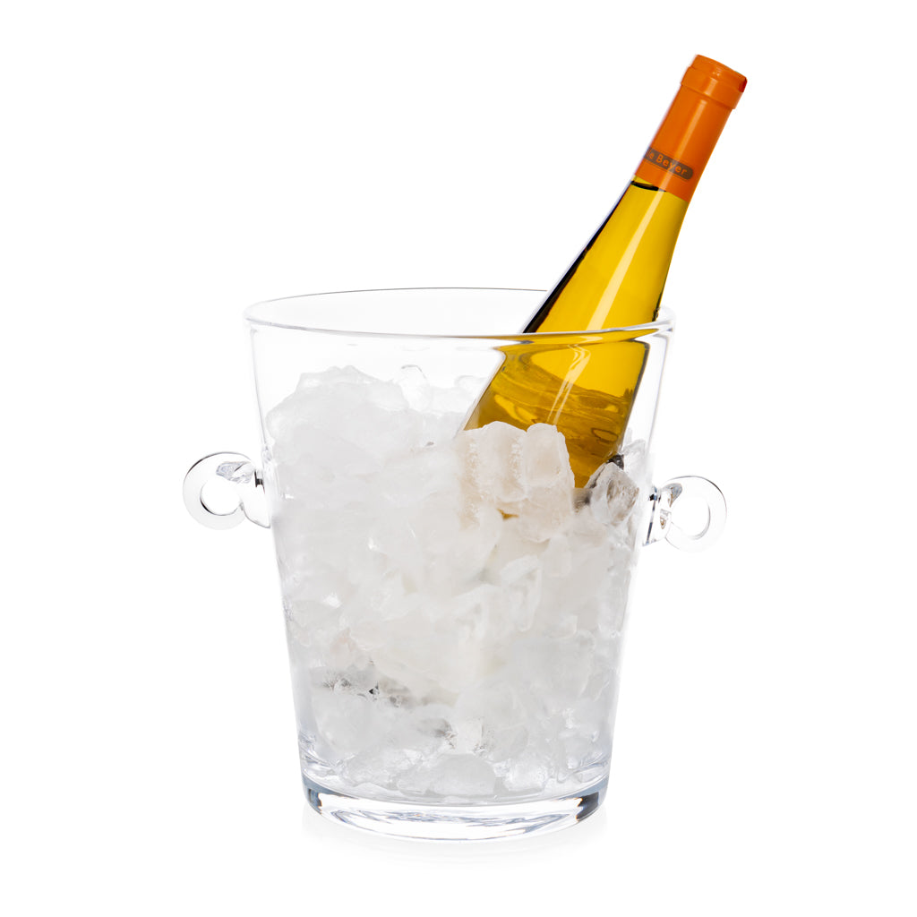 Handblown clear glass ice bucket with ring handles, filled with ice and a white wine bottle.
