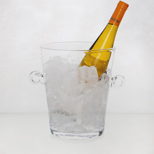 Handblown clear glass ice bucket with ring handles, filled with ice and a yellow wine bottle.