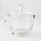 Clear recycled glass juicer with ribbed cone, handle, spout, and engraved measurements.