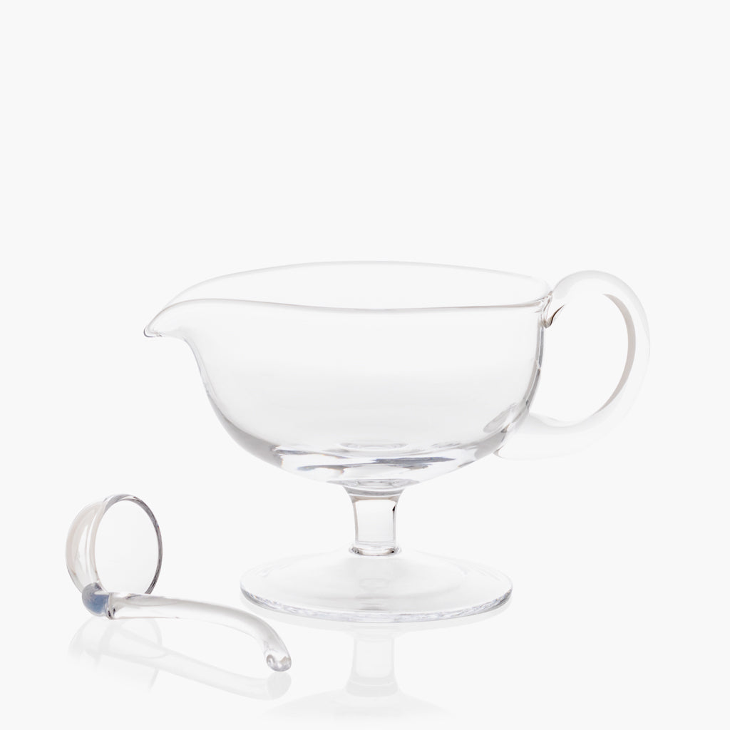 Clear glass sauce/gravy boat with handle and spout, 12.5 oz, with matching glass ladle.