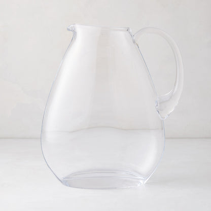 Clear, mouth-blown glass teardrop pitcher with handle and sturdy base.