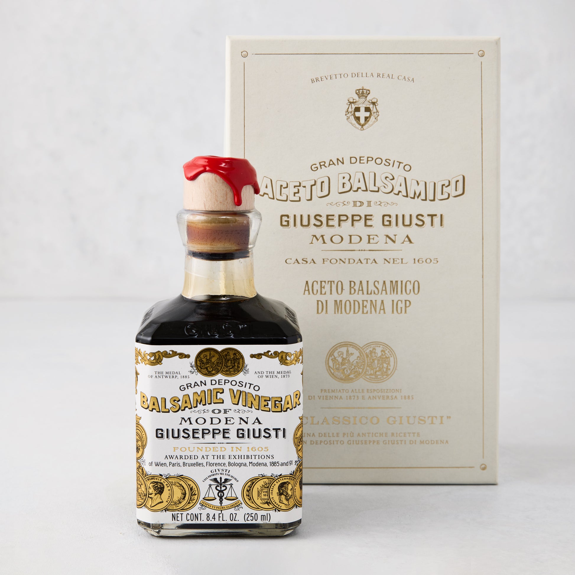 Giuseppe Giusti Gold Medal Balsamic Vinegar, 8.4oz bottle with red wax seal, next to an elegant cream box.