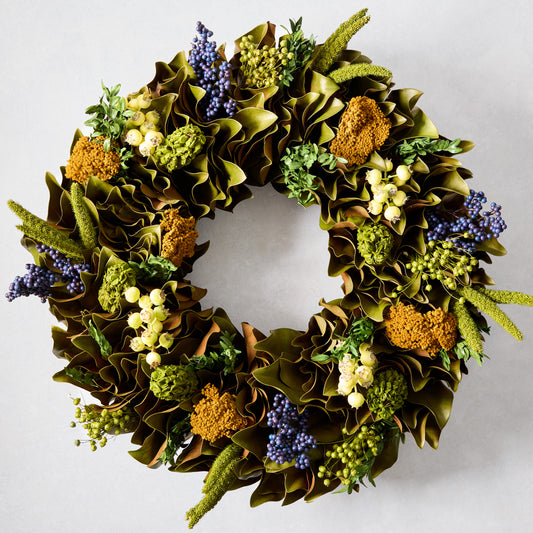 Golden Dawn Wreath with magnolia leaves, blue juniper, canella berries, rosehips, and golden yarrow.