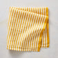 21-inch square cotton napkin with golden yellow and white ticking stripes and a yellow border.