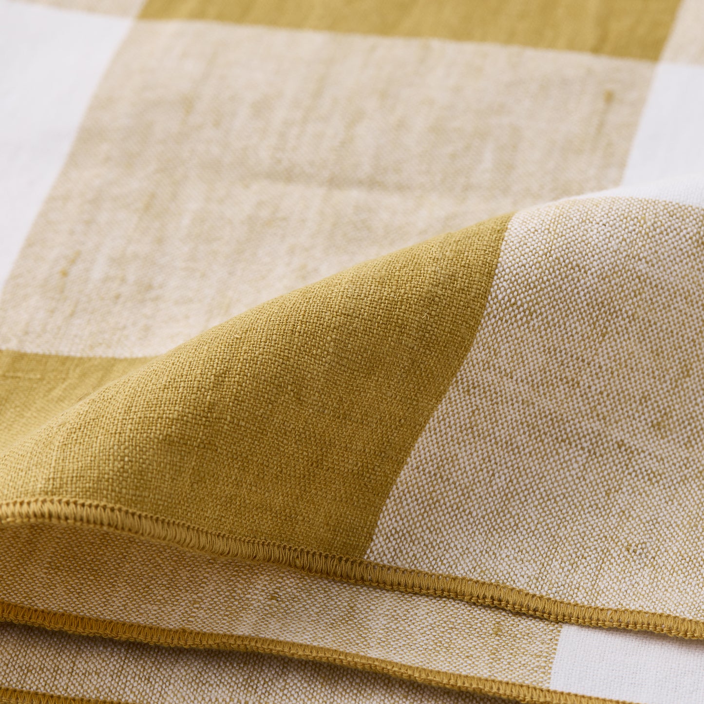 Goldenrod Buffalo Check Linen Napkin, 20"x20", folded, showing gold yellow and white squares.