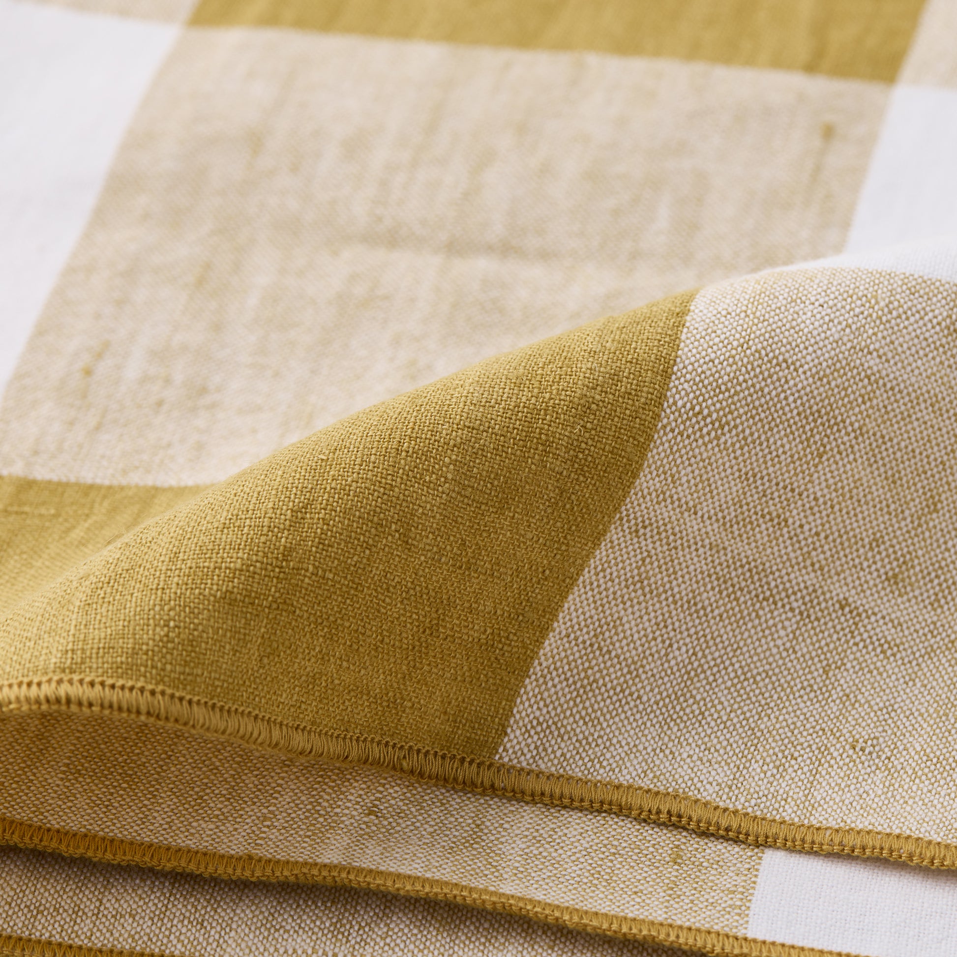 Goldenrod Buffalo Check Linen Napkin, 20"x20", folded, showing gold yellow and white squares.