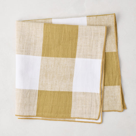 Goldenrod Buffalo Check Linen Napkin, 20" x 20", folded, with gold yellow and white squares.