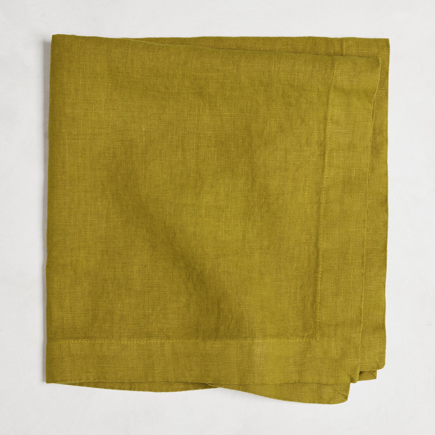 Goldenrod HG Signature hand-dyed linen napkin, 22-inch square, folded, with mitered corners.