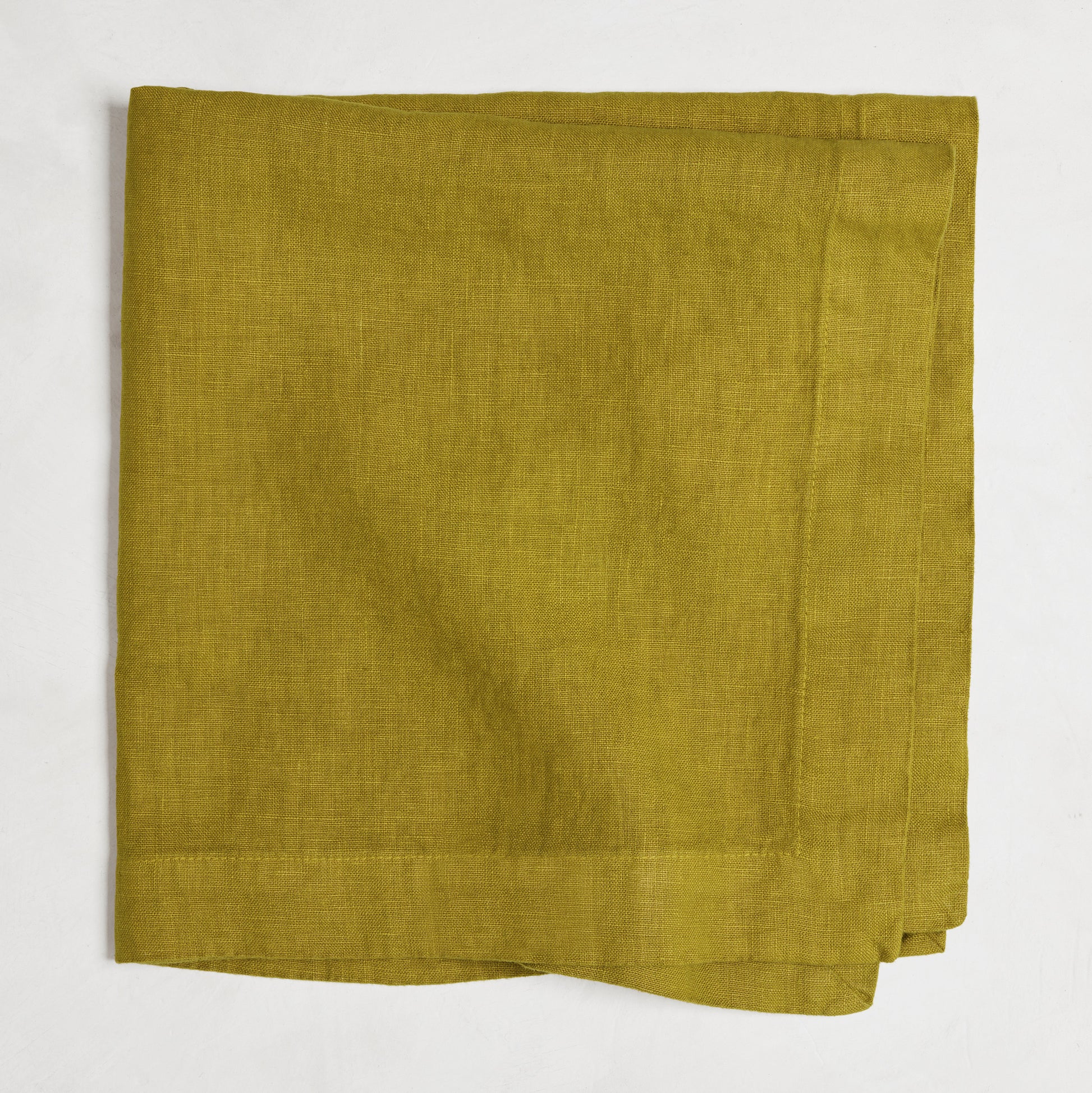 Goldenrod HG Signature hand-dyed linen napkin, 22-inch square, folded, with mitered corners.