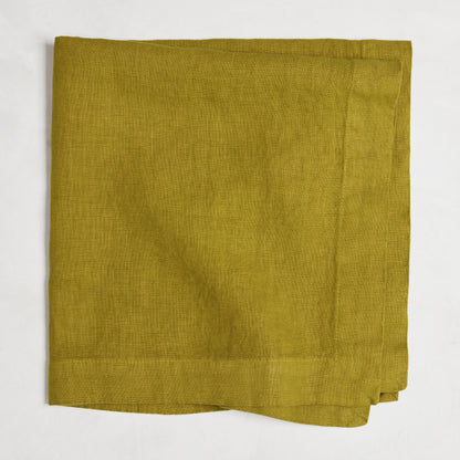 Goldenrod HG Signature hand-dyed linen napkin, 22-inch square, folded, with mitered corners.