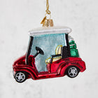 Red glitter glass golf cart Christmas ornament with clubs.
