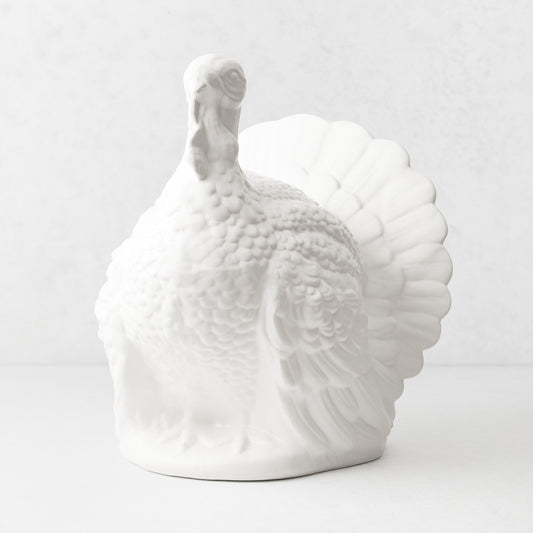 Oversized matte white ceramic turkey centerpiece with detailed feathers and fanned tail, 15 inches tall.