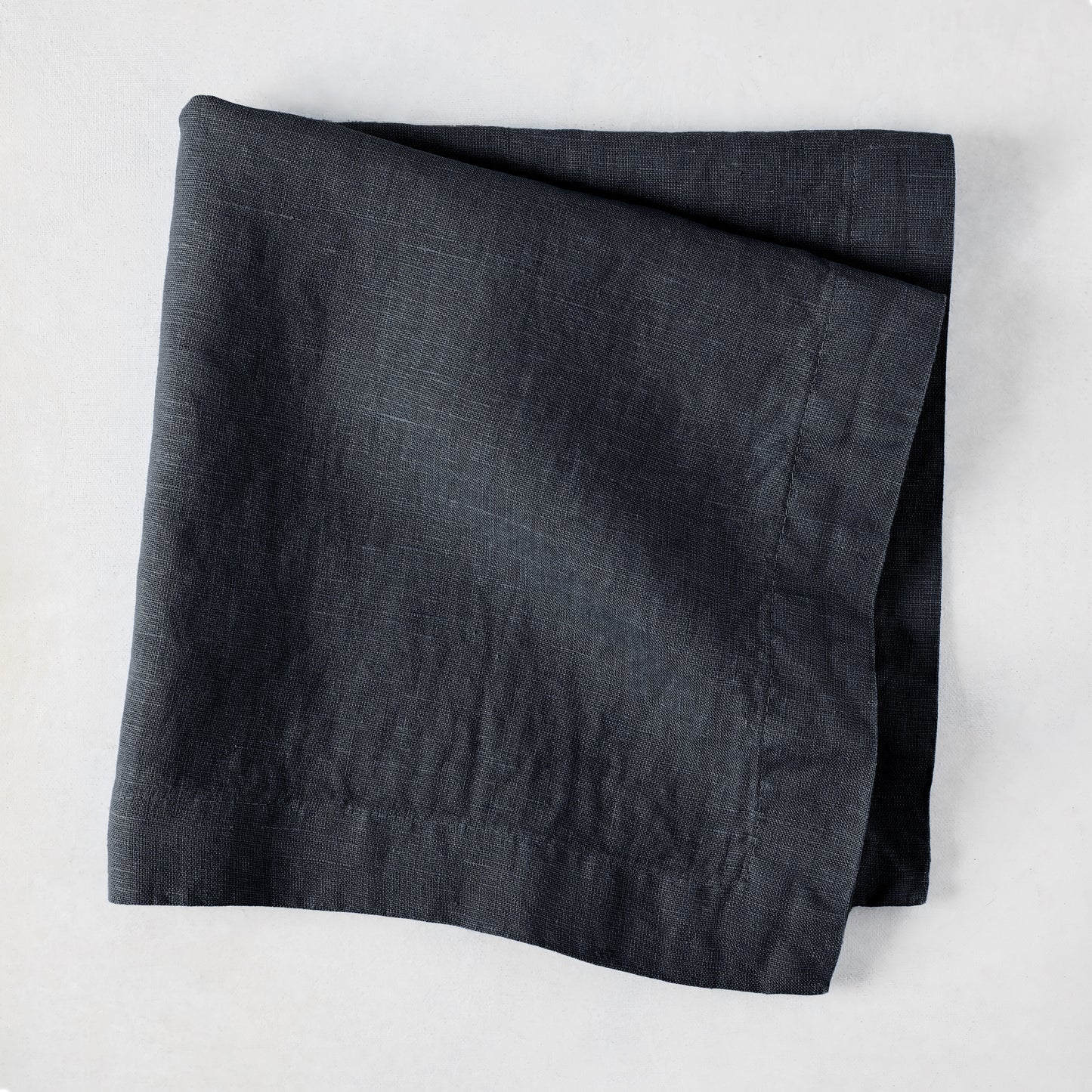 Graphite HG Signature hand-dyed 22-inch square linen napkin, folded.
