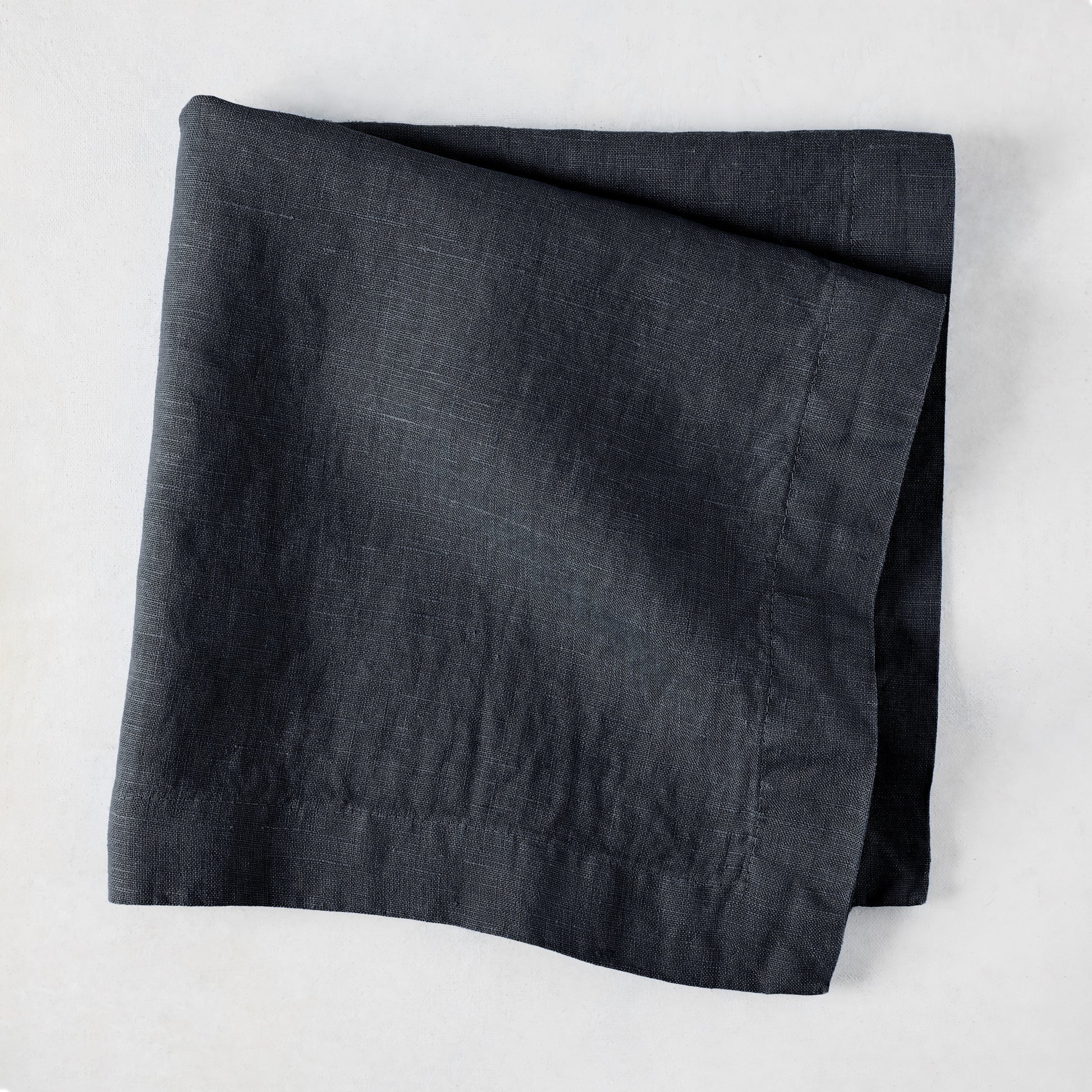 Graphite HG Signature hand-dyed 22-inch square linen napkin, folded.