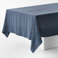 Graphite hand-dyed linen tablecloth with a wide border and mitered corner detailing on a white display block.