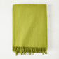 Grass green cashmere throw blanket with classic fringe.