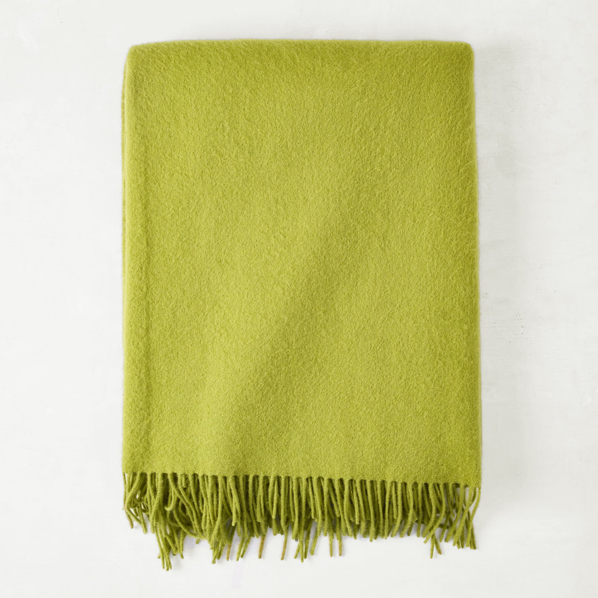 Grass green cashmere throw blanket with classic fringe.