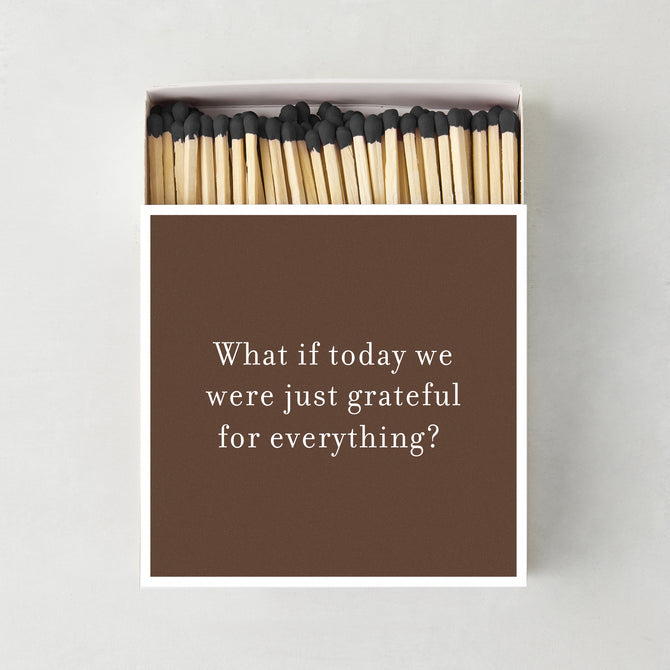 Oversized matchbox in brown with white text reading Grateful for Everything, containing 4-inch matches with black tips.