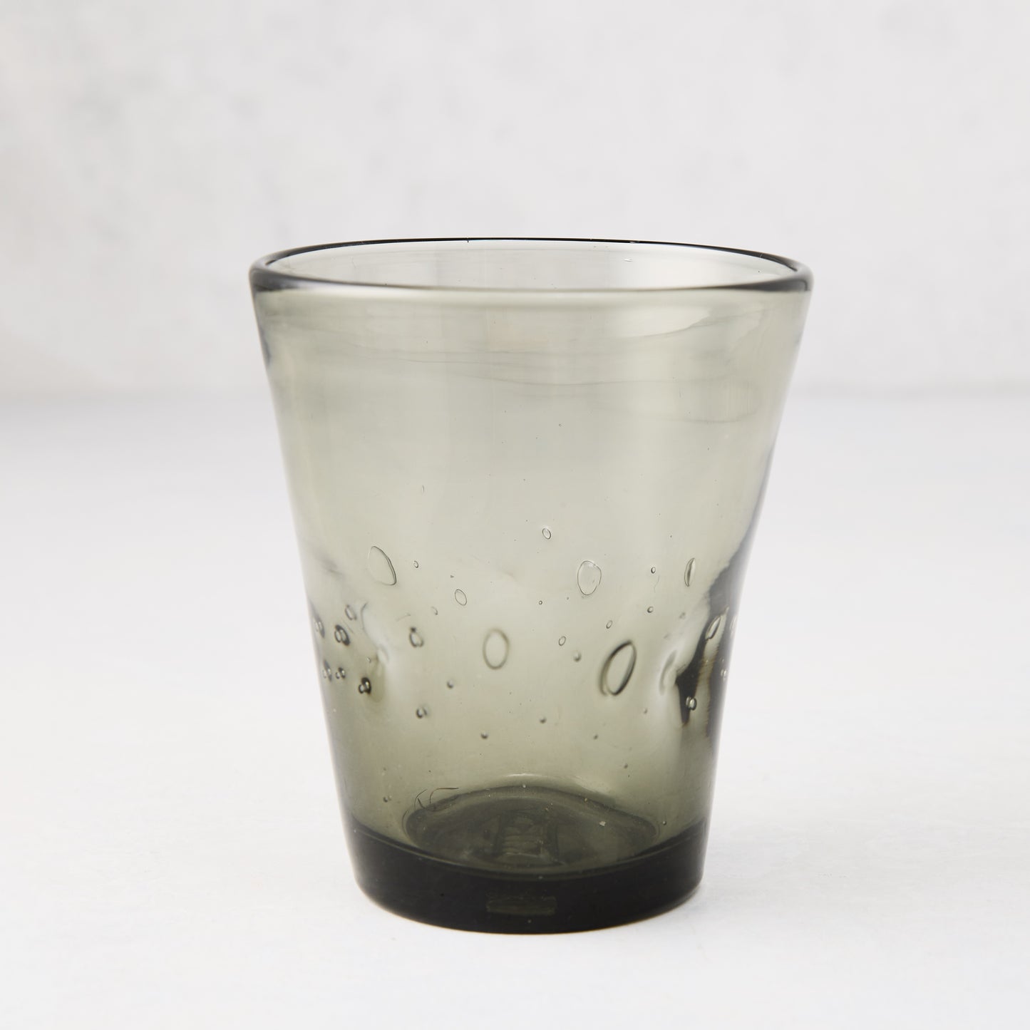 Handmade grey Henri glass, 8 oz, with unique air bubbles and slight asymmetry.