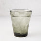 Grey Henri mouth-blown glass, 8 oz, filled with ice and a bubbly drink.