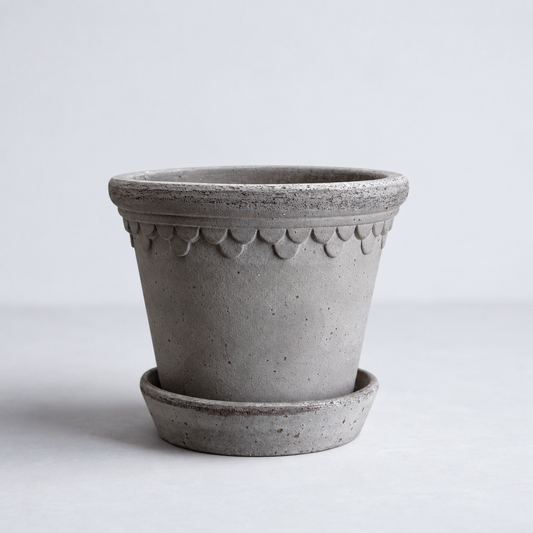 KØBENHAVNER gray terracotta pot and saucer with scalloped rim detail, 8.3-inch diameter.